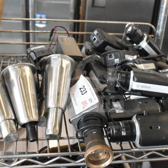 16 Bosch cameras and metal legs, mixed lot, visible tags with lot number 233, on metal shelf.