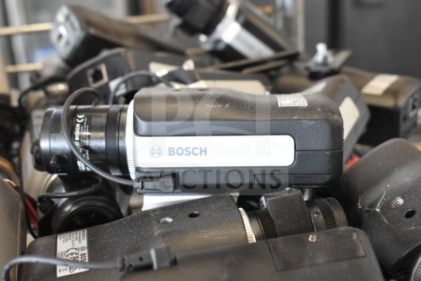 Bosch cameras with visible lenses, cables, and condition markings, part of auction lot of 16 varied items.