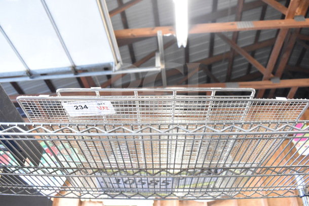 Metal wire racks with grid pattern, labeled lot 234. Auction includes two items; bid doubles. New condition.