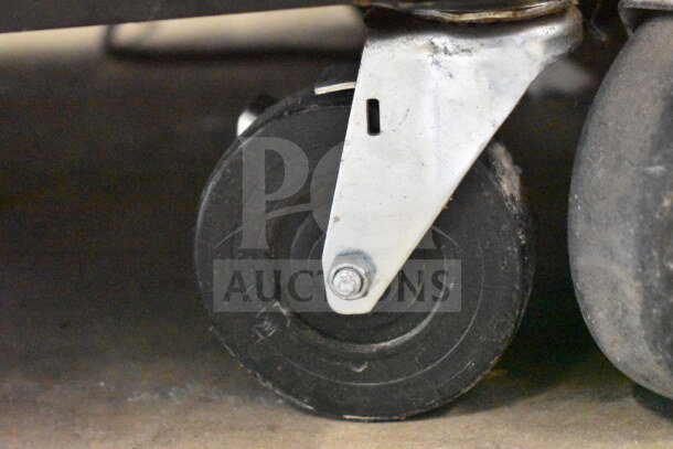 Commercial caster wheel of 2019 True T-23F-HC Reach-In Freezer, showing metal bracket and rubber wheel, for easy mobility.