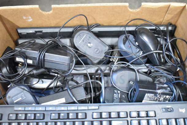 A box with 25 various computer mice and keyboards, mixed brands and models, showing cords and some wear.