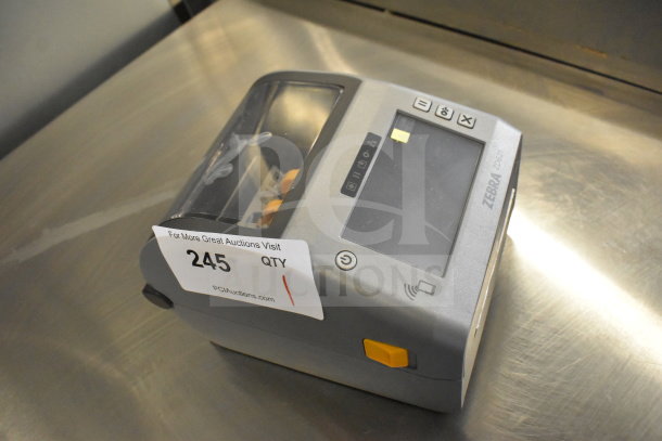 Zebra ZD621 Desktop Direct Thermal Barcode Printer, gray with touch screen, label number 245 visible, in used condition.
