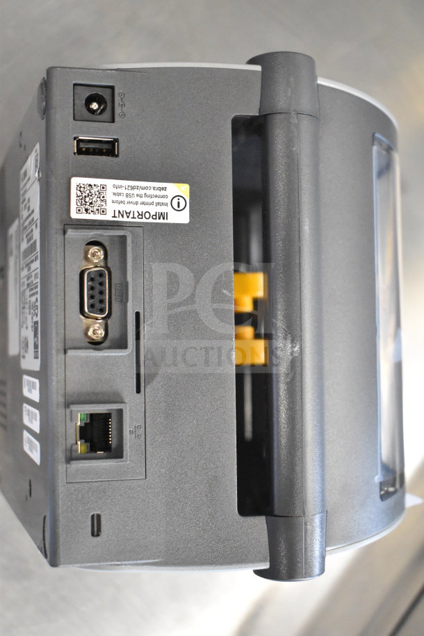 Zebra ZD621 desktop direct thermal barcode printer with USB and Ethernet ports, minor surface wear, and label with QR code.
