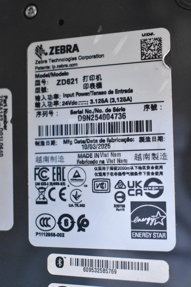 Zebra ZD621 desktop barcode printer label, model ZD621, showing serial number D9N254004736, manufactured on 10/03/2025.