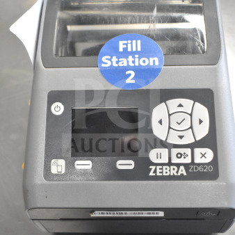 Zebra ZD620 desktop direct thermal barcode printer. Features control panel, media sensor. Marked "Fill Station 2." Good condition.