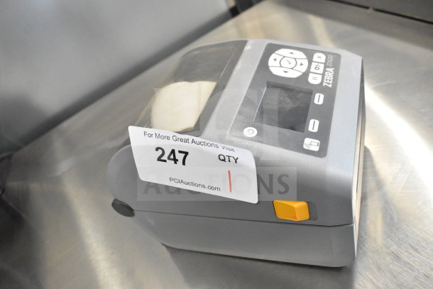 Zebra ZD620 desktop direct thermal barcode printer, gray, with control panel and auction tag 247 visible, in good condition.