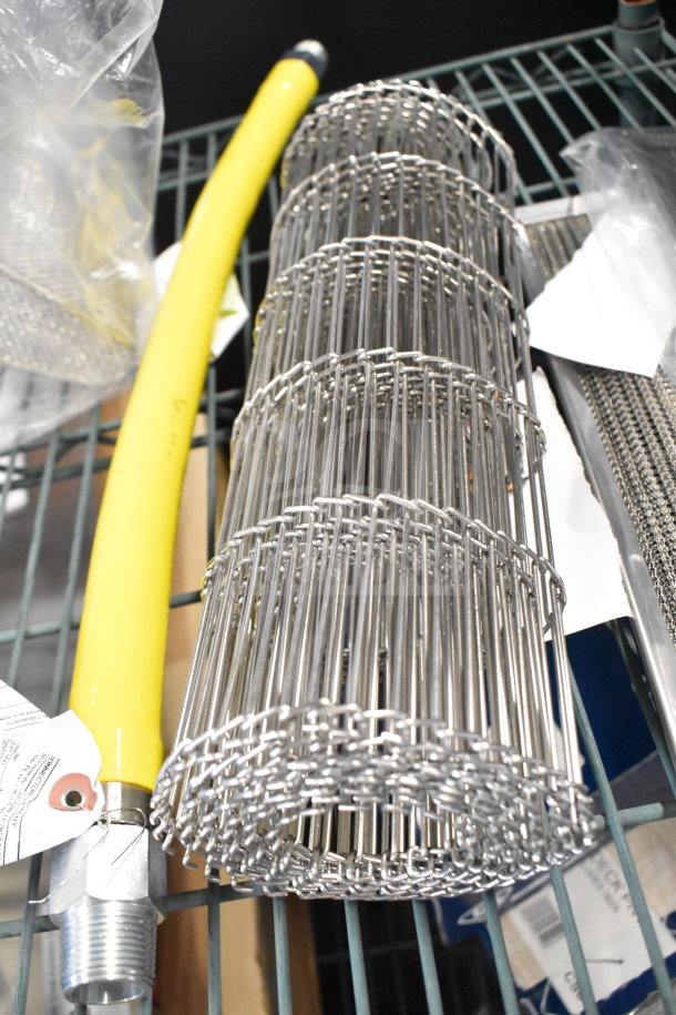 Brand new Alto-Shaam 5024003 air filter for VMC, metal conveyor belt, and yellow hose on shelf with tags visible.