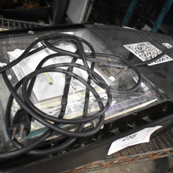 Black light fixture with clear lens, attached power cord, and visible QR code on casing. Auction tag reads "258".