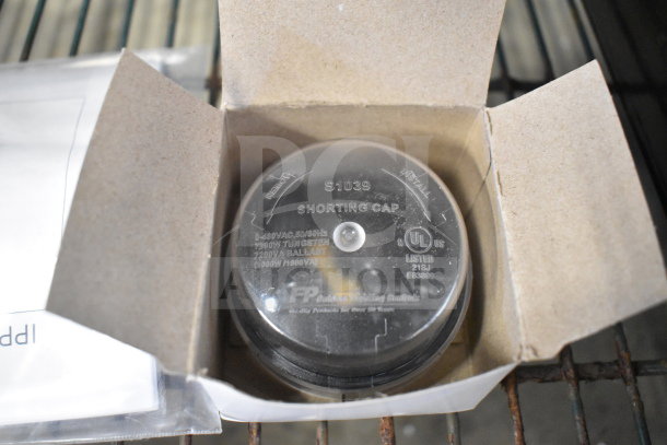 Shorting cap in box, labeled S1039, UL listed for 0-480VAC, 50/60Hz. Additional manuals visible. Auction lot of three items.
