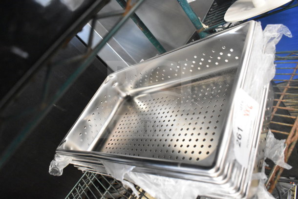 Perforated stainless steel drop-in bin, new condition, with item tag indicating auction lot number.