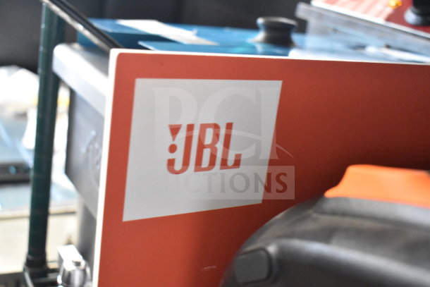JBL store display featuring Partybox 110 speaker, showcasing brand logo; condition appears intact and clean.