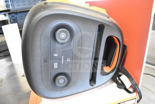 JBL Partybox 110 speaker on display, featuring Bass Boost, Bluetooth, and power controls. Excellent condition.