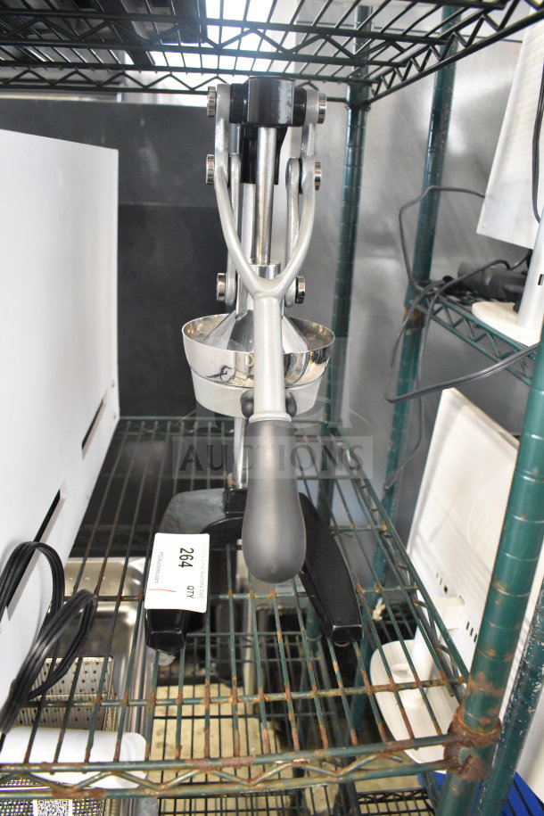 Brand new Choice 407MCJ2 manual heavy-duty citrus juicer on metal rack; minor scratches visible; item tag reading 264.