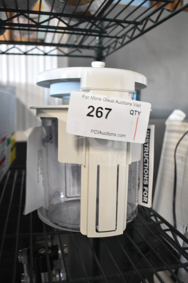 BRAND NEW SCRATCH AND DENT Sunkist CCP27 countertop juicer, white, with attached auction tag and visible instructions.