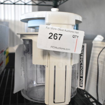BRAND NEW SCRATCH AND DENT Sunkist CCP27 countertop juicer, white, with attached auction tag and visible instructions.