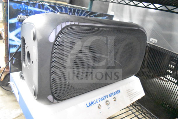 Onn Large Party Speaker on store display, black with visible mesh grill, buttons labeled on base; excellent condition.