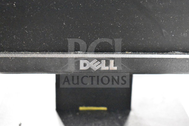 Six computer monitors, brands including Dell and HP, in used condition; Dell logo visible on one screen.
