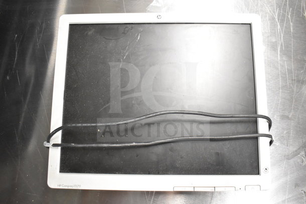 HP Compaq LE1711 monitor on metal surface, visible screen wear, attached cable. Auction lot of 6 including Dell, HP.