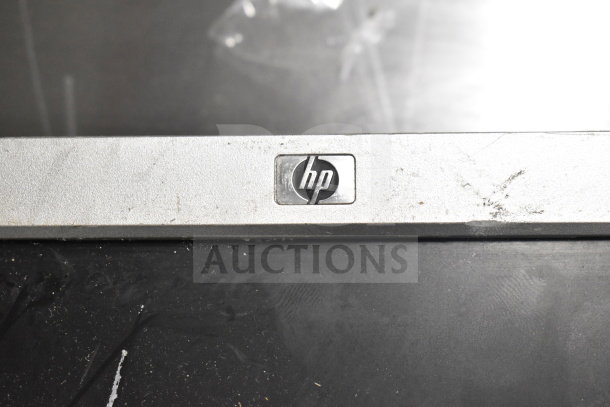 Six various computer monitors including Dell and HP, featuring visible HP logo, showing moderate wear.
