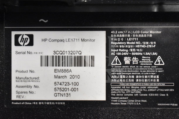 HP Compaq LE1711 monitor label showing model, serial number, product details, and input rating information.