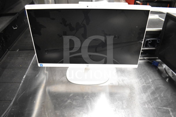 6 computer monitors, including Dell and HP, various models, on a table. Some wear visible. Multiple purchase value.