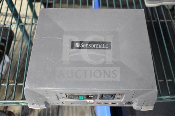 Sensormatic ZBSMPROE antenna deactivator, used, dark gray, visible power and connection ports, branded label on top.