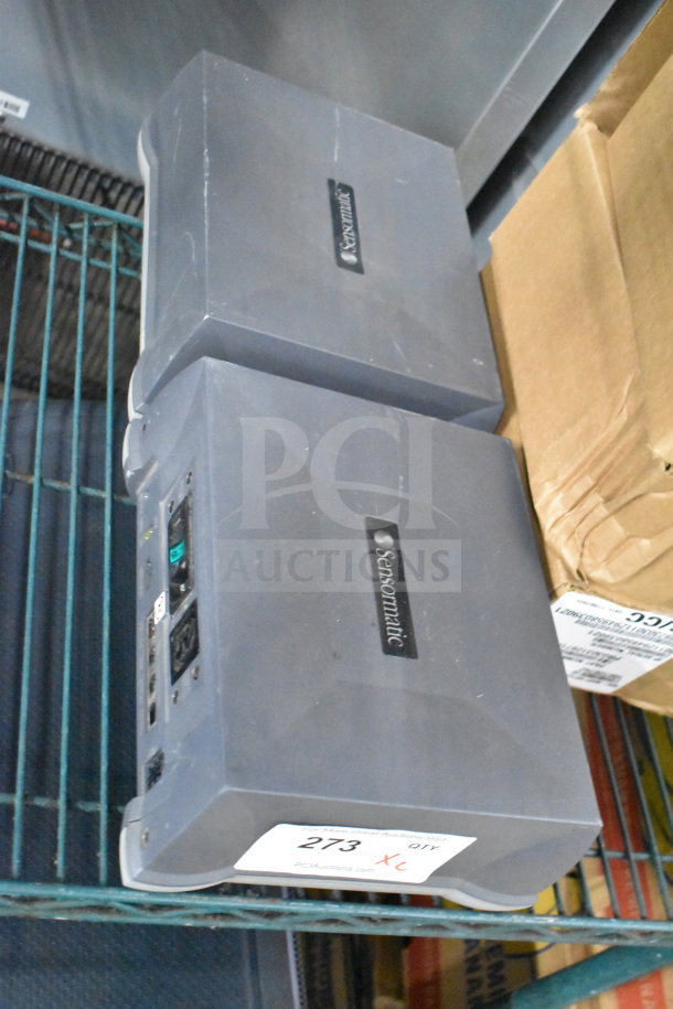 Two Sensormatic ZBSMPROE antenna deactivators, gray, with logo. Features control panel and label indicating quantity.
