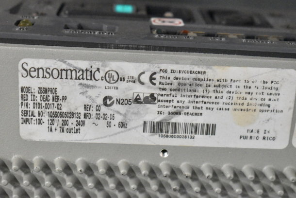 2 Sensormatic ZBSMPROE Antenna Deactivators; FCC and UL compliant, made in Puerto Rico. Model, serial, and power specs visible.