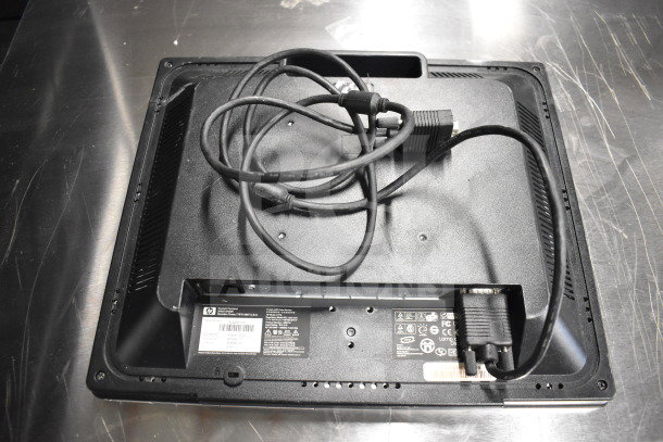 Back of an HP monitor with attached cables. Visible labels show model and regulatory information. Part of an 8-monitor lot.