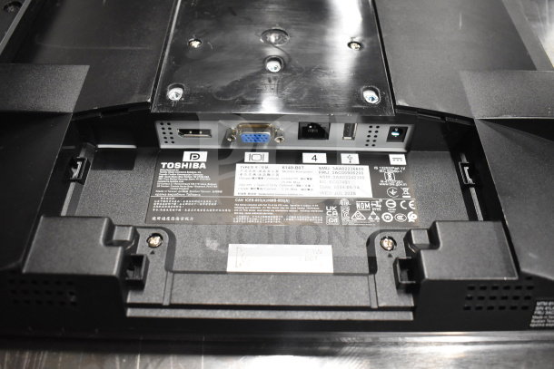"Rear view of a Toshiba monitor showing various ports and label details, part of an 8-monitor lot including HP and Onn."