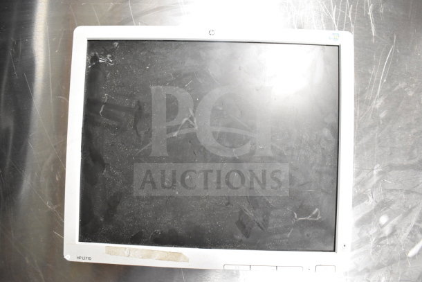 8 mixed monitors including Toshiba, HP, and Onn. Visible HP L1710 model, showing wear. Auction includes 8 units.