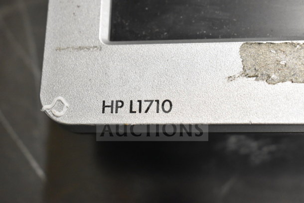 HP L1710 monitor close-up showing the model number on a silver frame, some wear visible on the surface.