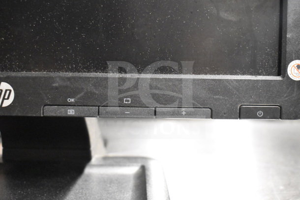 8 monitors including HP, Toshiba, and Onn, with visible buttons and labels. Multi-brand lot for auction; used condition.