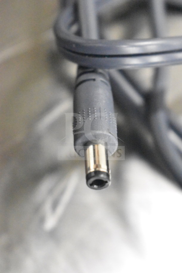 Close-up of a gray DC power connector cable, highlighting the plug end.