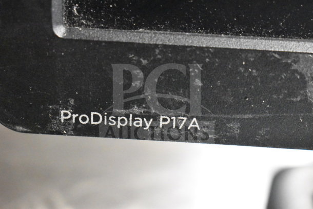 Close-up of HP ProDisplay P17A monitor label showing model number, indicating its inclusion in an 8-monitor auction lot.