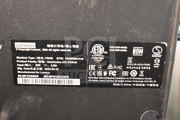 Black label on Lenovo device showing model F0HM00HVUS, part of IdeaCentre AIO 27IRH9 series, with various certifications.