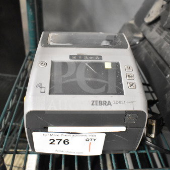 Zebra ZD621 desktop direct thermal barcode printer on shelf, showing control panel. Label with auction info attached. Used condition.