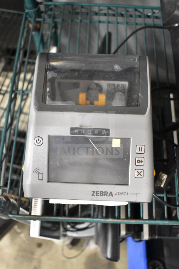 Zebra ZD621 desktop direct thermal barcode printer, grey, displaying minor scratches. Brand and model visible on front.