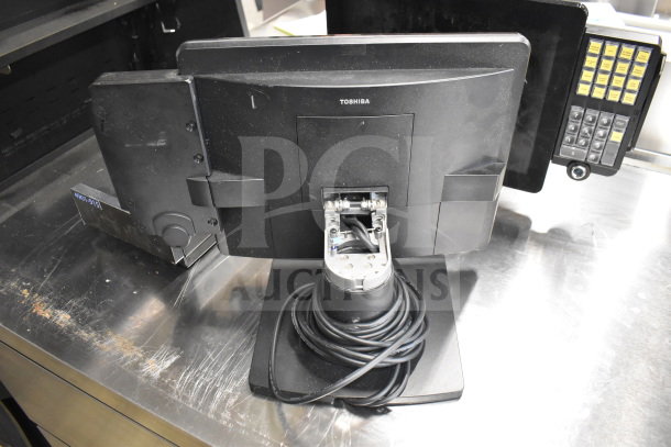Toshiba monitor with base, cables wrapped, slight wear. Part of a lot with office phone and receipt printers.