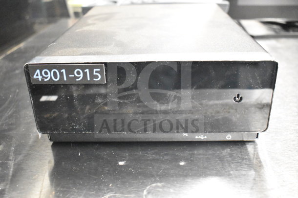 Black electronic device with power button and USB port; labeled "4901-915"; part of auction lot with Toshiba monitors, phone, printers.