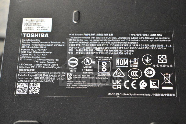Labels and certifications on Toshiba device, including FCC compliance details and product specifications.