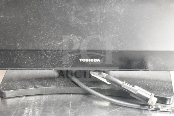 Toshiba monitor with base stand and connected power cable, visible wear. Auction includes 15 mixed office items.