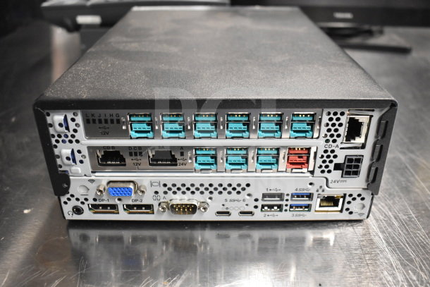 Back view of a computing device with multiple connectivity ports, including USB, Ethernet, and VGA. Good condition.