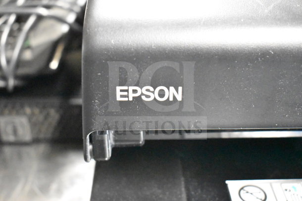 Epson receipt printer with visible branding, part of a lot including Toshiba monitors and office equipment.