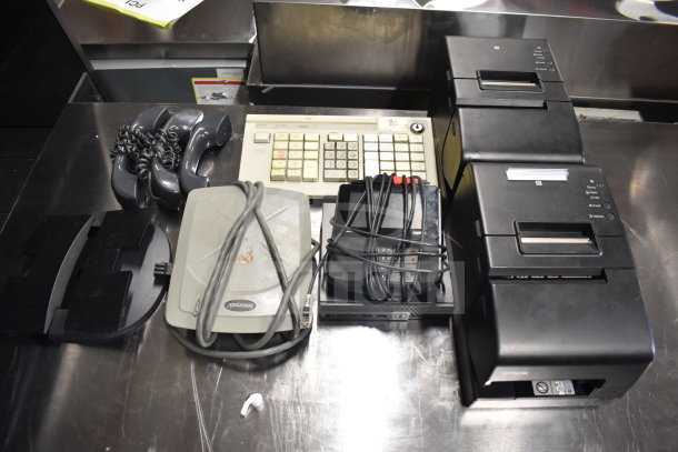 Various items including Toshiba monitors, corded office telephone, Epson receipt printers, and cables. Mixed condition.