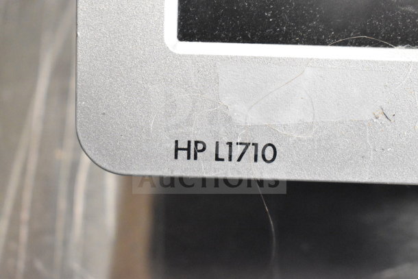 HP L1710 monitor corner with visible model number, part of a 15-item auction lot including Toshiba monitors and office equipment.