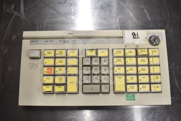 Keypad device with multiple labeled buttons including "Money Order" and "Price Override." Slight wear visible; marked "81."