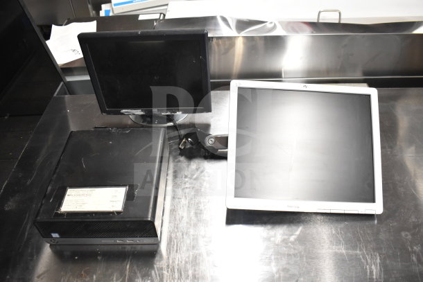 15 mixed electronics including Toshiba monitors, office phone, and receipt printers. Shows monitors on stainless surface.