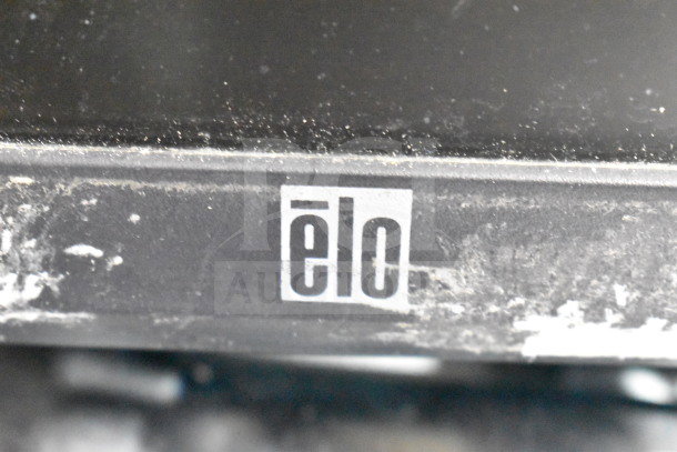 Alt text: Close-up of an Elo branded device, showing signs of wear and dust buildup.