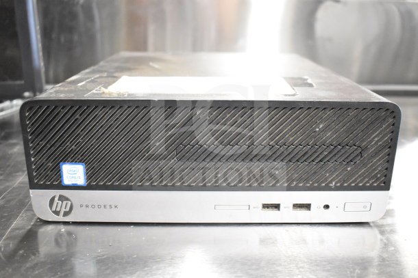 HP ProDesk desktop, Intel Core i5, 8th Gen, front view showing ports and power button. Signs of wear visible.